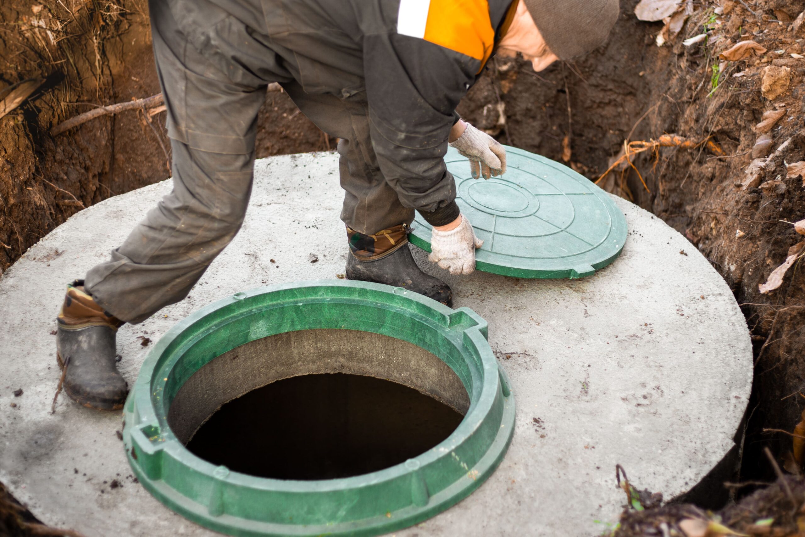 person servicing septic tank